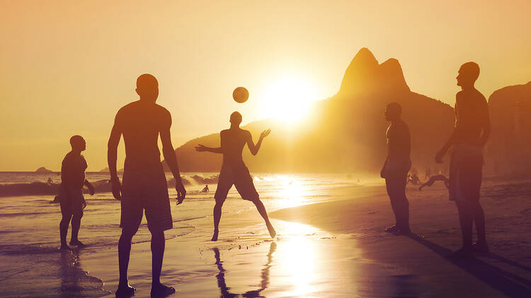 Ipanema beach at sunset, people playing volleyball